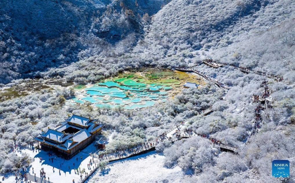 Early Mid-Autumn Snowfall Blankets Northern China The Huanglong Scenic and Historic Interest Area in Sichuan is covered in its first snowfall. Photo: Sun Jiapeng/Xinhua.