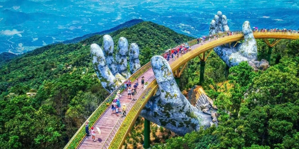 North vs South Vietnam: Which Should Explore First The Golden Bridge in Da Nang is a spectacular pedestrian walkway supported by two colossal stone hands in the Bà Nà Hills.