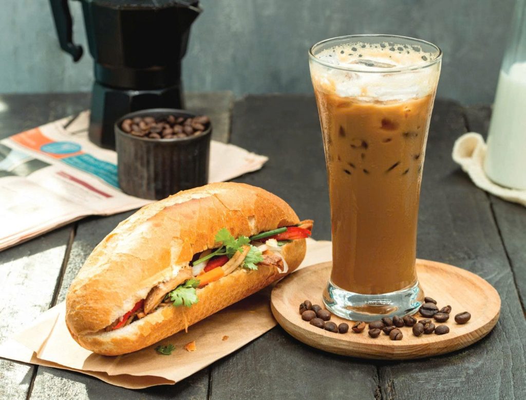 North vs South Vietnam: Which Should Explore First Banh Mi and strong Iced Coffee (Cà Phê Sữa Đá) are iconic Vietnamese street foods.