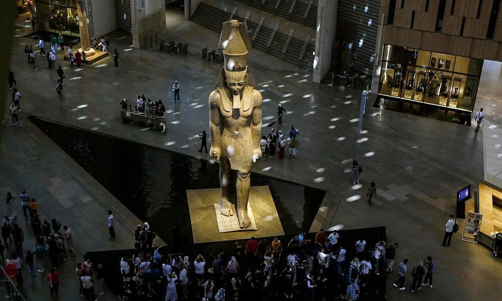 The colossal 11-meter-tall statue of Pharaoh Ramses II, weighing 83 tons, is positioned at the center of the museum's Grand Hall.